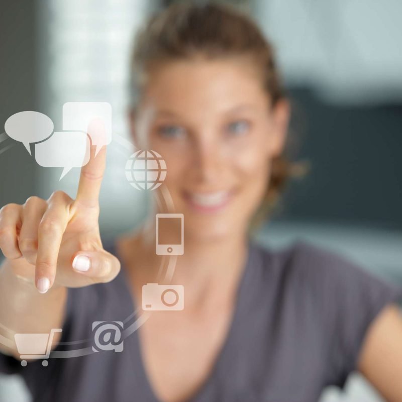 Smiling woman  pressing  touch screen on social network icon